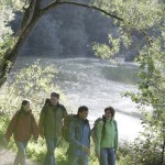 Four hikers alongside a lake